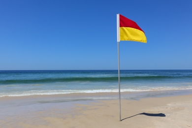 red and yellow flag on beach