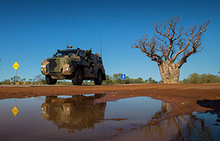 An Australian Army Bushmaster protected mobility vehicle from 1st Brigade drives along the Great Northern Highway during exercise Northern Shield 2016. © Commonwealth of Australia, Department of Defence