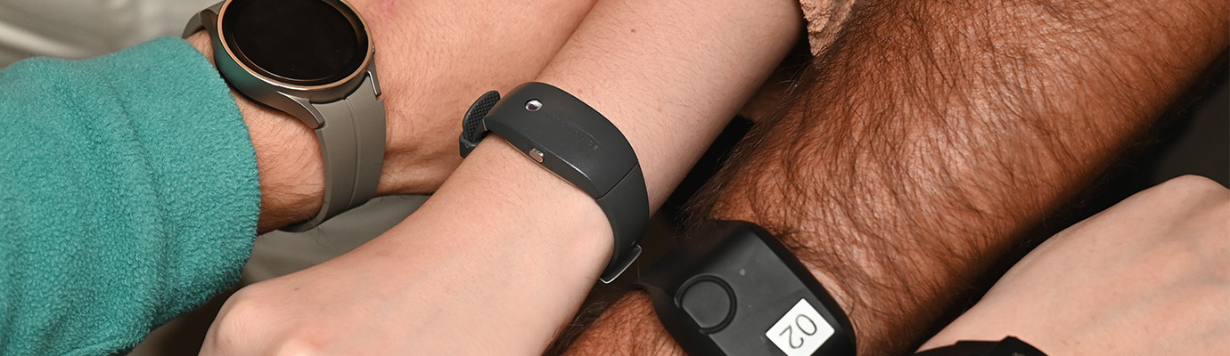 Four people and their arms with smart watches