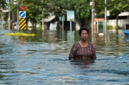 Woman walking through flood waters. 