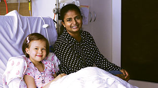 Volunteer Ayesha Fernando with leukaemia patient Sadie.