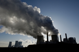 Silhouette of a power plant with pollution