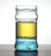 glass jar with oil and water in it