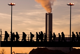 Retrenched workers leaving factory at dusk