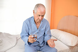 Elderly man taking his pills