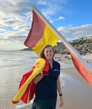 Sarah Cutbush on the beach with Surf Life Saving jacket