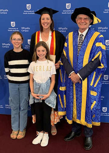 UniSA Chancellor John Hill at the Whyalla graduation ceremonies last month, pictured with Stacey Franklin (and family) who graduated from a Grad Dip Urban and Regional Planning