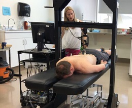 Researcher Tasha Stanton applies pressure to a man with chronic back pain
