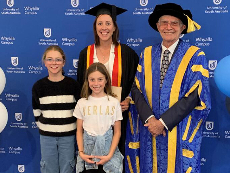 UniSA Chancellor John Hill at the Whyalla graduation ceremonies last month, pictured with Stacey Franklin (and family) who graduated from a Grad Dip Urban and Regional Planning