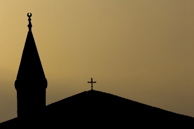 Silhouettes of the steeples of a mosque and a church