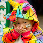 Charlie in his rainbow dinosaur costume