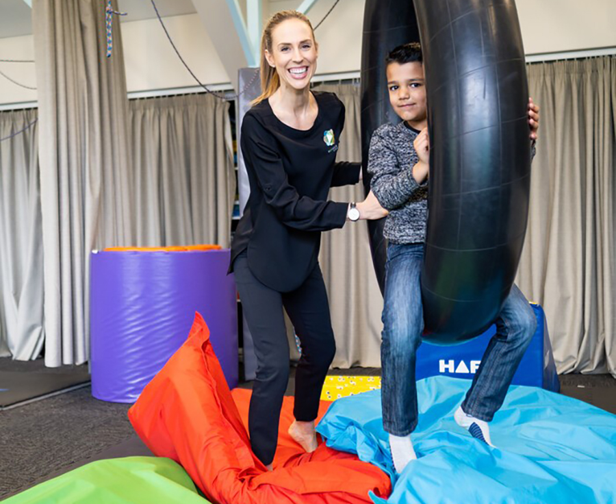 Rochelle Mutton assisting a child in the gym