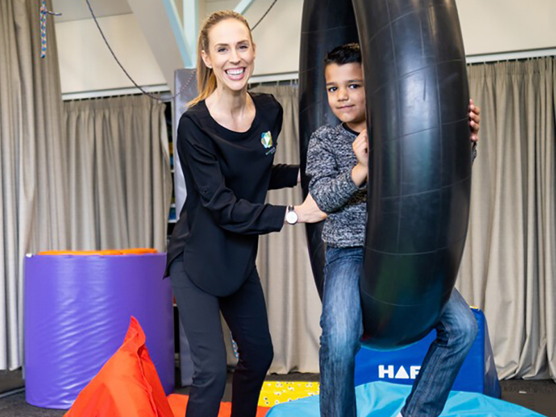 Rochelle Mutton assisting a child in the gym 