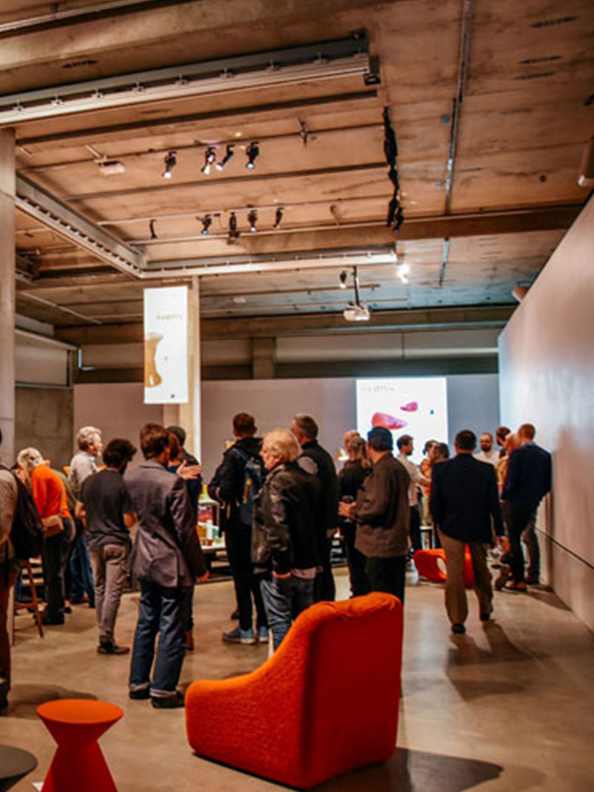 A large gathering of people in a gallery space