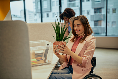 Woman returning to work and setting up desk