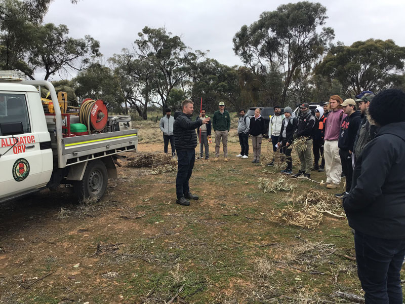 Travis Thomas, UniSA alumnus, director of the Nukunu Wapma Thuru Aboriginal Corporation, Chair of the First Nations of SA Aboriginal Corporation and CFS brigade captain, shares his knowledge of fire safety with students before the leading a cultural burn.