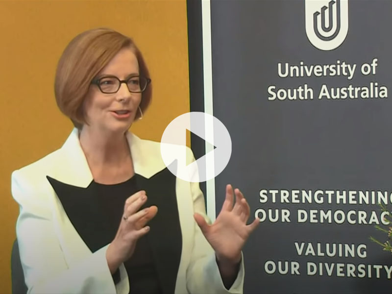 The Hon Julia Gillard AC with the cover of her book Women and Leadership: Real Lives, Real Lessons