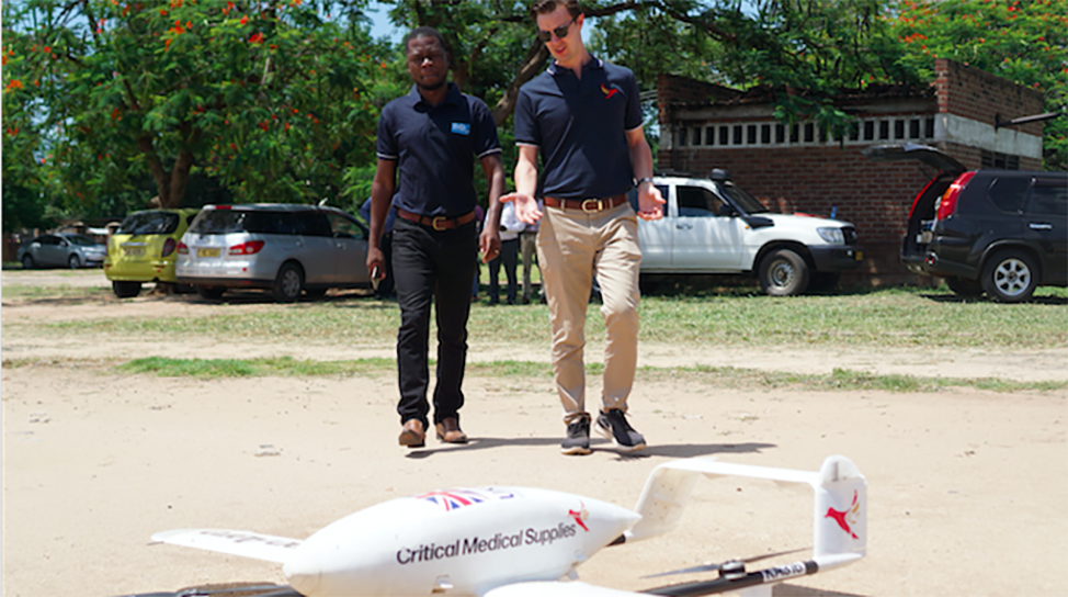 Eric (right) on a recent trip to Malawi with the Swoop Aero drone