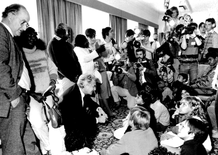 Image: Prime Minister, Bob Hawke and Minister for Aboriginal Affairs, Clyde Holding and the media with Kakadu school children in September 1985 (NAA: A6180, 11/9/85/3). Image courtesy of the National Archives of Australia, digitised from photographs in the Bob Hawke Collection.