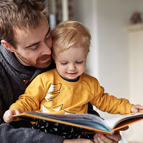 Dad reading a book to a child