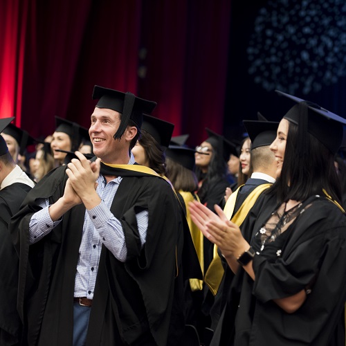 UniSA graduates in caps and gowns. 