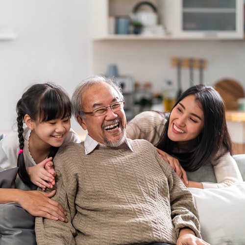 Grandchild, parent and grandparent laughing together.