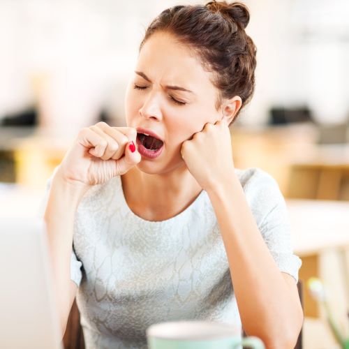 Woman yawning at work