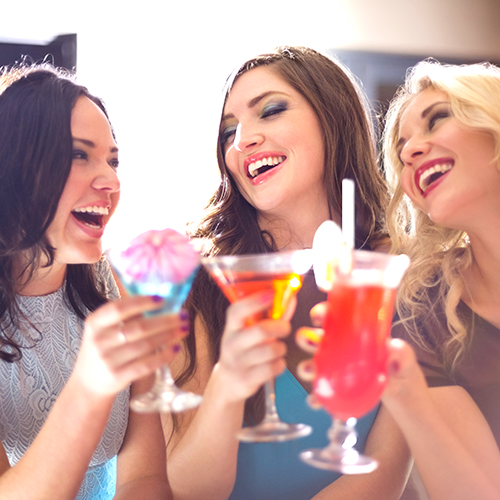 young women drinking cocktails