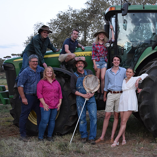 Farming family in front of truck