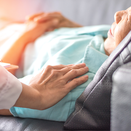 Person in hospital bed with golden light