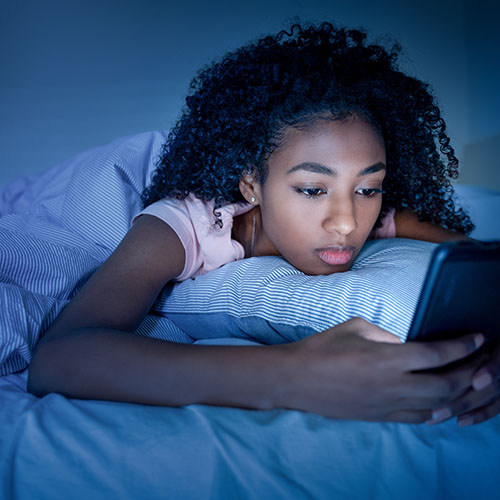 teenager girl on tech at night -shutterstock_2051940584_web.jpg