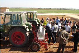 Tractor in field with group of farmers