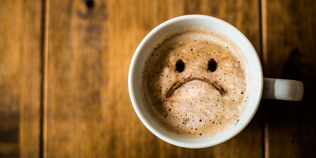 Cup of coffee with a sad face
