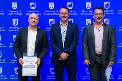 Professor John Hayball (left) and Professor Krasi Vasilev (right) won the UniSA Interdisciplinary Award for their research. They are pictured with Deputy Vice Chancellor for Research and Innovation Professor Simon Beecham at the UniSA Research Awards.