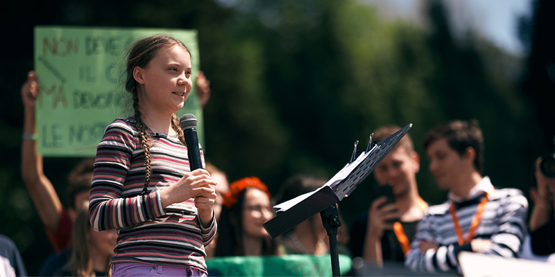 ROME, ITALY - April 19, 2019: Swedish climate activist Greta Thunberg attending Fridays For Future (School Strike for Climate) protest in front of a huge crowd near the Colosseum. Editorial credit: / Shutterstock.com 