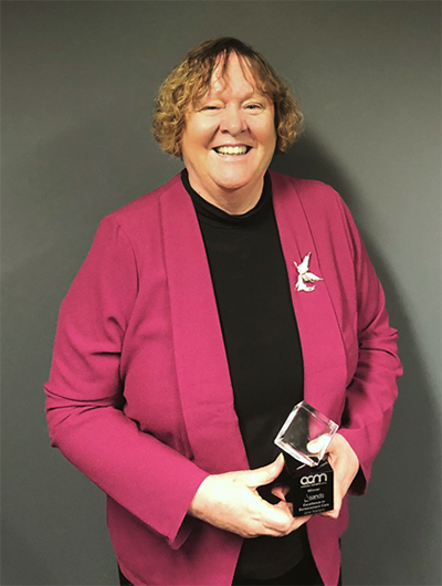 Associate Professor Jane Warland holding her Excellence in Bereavement Care Award.