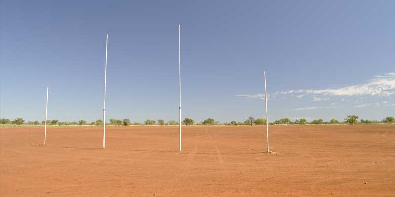 Deserted dusty Australian Rules Football oval in outback Australia.
