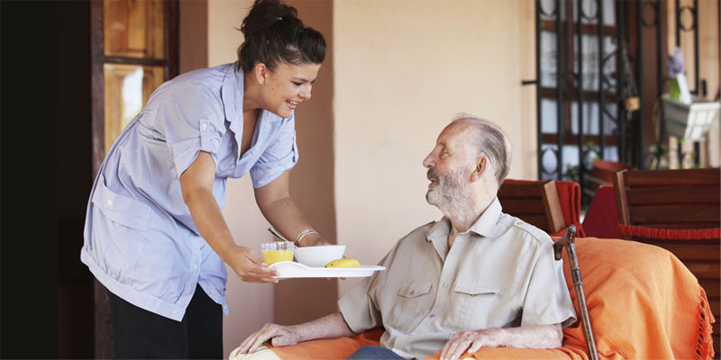 Man receiving a meal in a nursing home