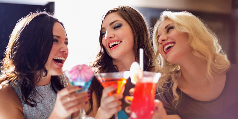 Young women drinking cocktails