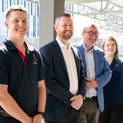 UniSA graduates Paul Summerton (far left) and Katrin Horsey (far right) now working for Nova Systems with UniSA Vice Chancellor Professor David Lloyd and Nova Group CEO Jim McDowell.