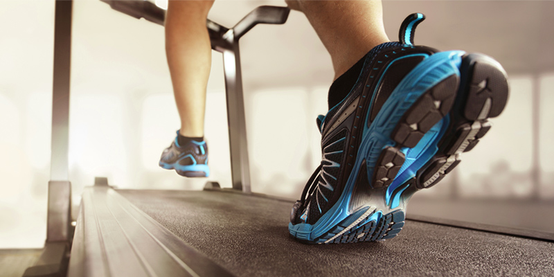Person running on a treadmill. Shutterstock