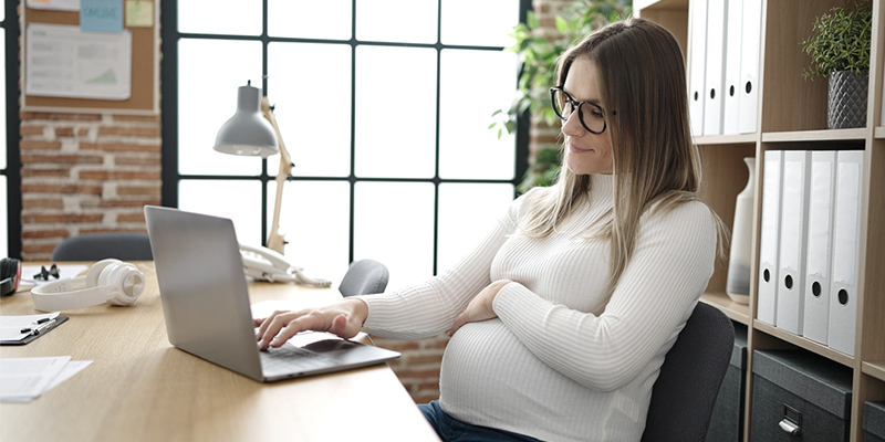 Pregnant woman working at desk