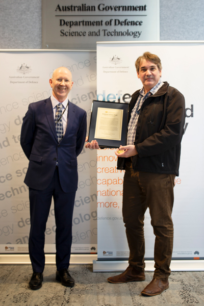 DSTG Acting Chief Platforms Dr Greg Bain (left) presents UniSA Professor Javaan Chahl with a Defence Commendation acknowledging his valuable partnership with DSTG and Defence.