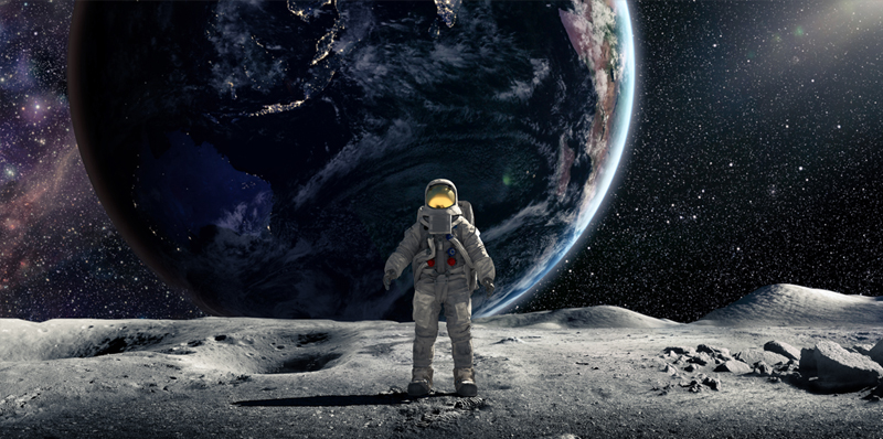 Astronaut standing on moon looking at Earth is the distance