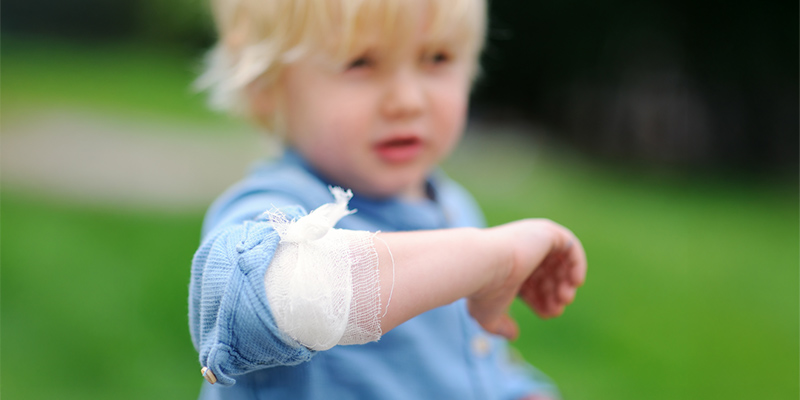 Small child with a bandaged arm