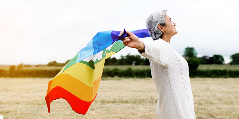 Older person with rainbow flag