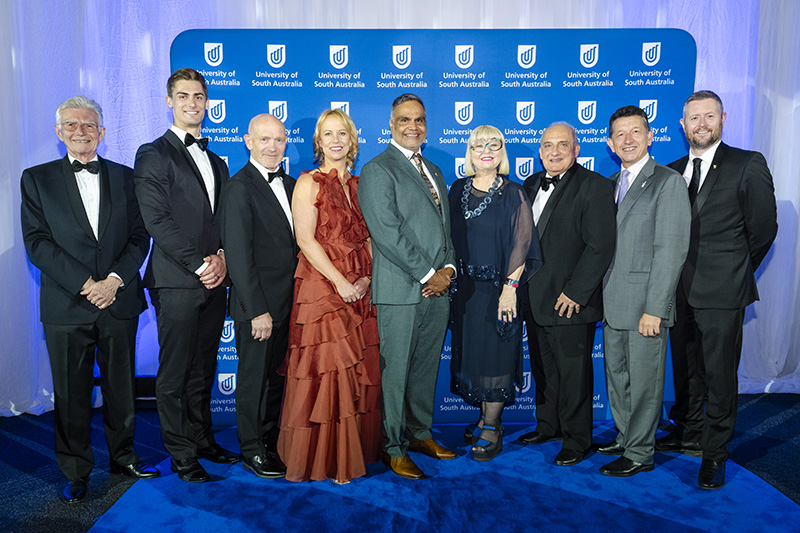 UniSA Chancellor John Hill (left) and Vice Chancellor Professor David Lloyd (right) wth the 2025 UniSA Alumni Award winners, L-R: Matthew Glaetzer, Eric Phillips, Louise Adams, Dale Agius, Heather Croall, Mario Verrocchi and Angelo Kotses.