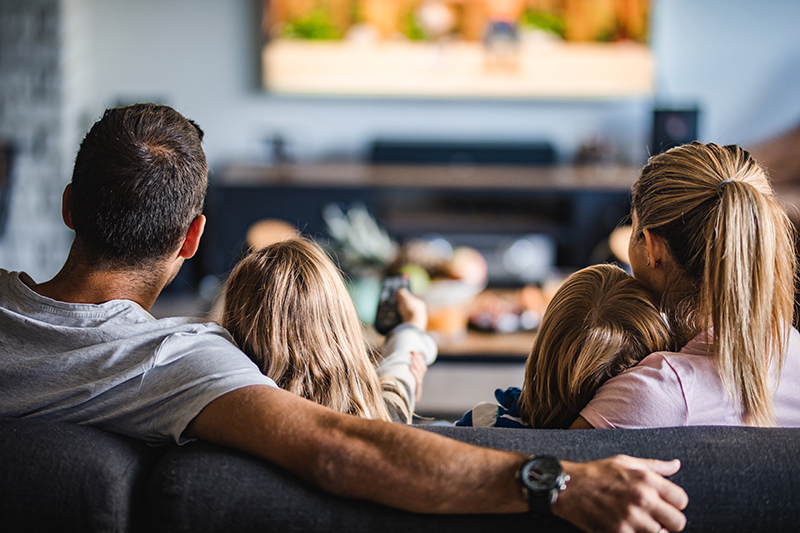 Parents watching tv with the kids